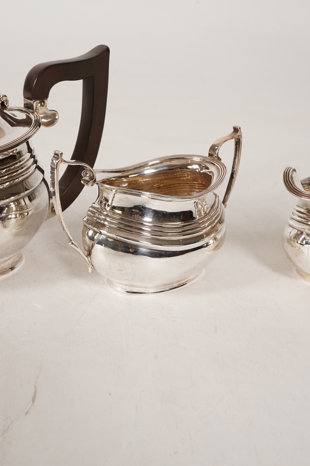 A George V four piece silver tea set, comprising teapot, hot water pot, sugar bowl and milk jug, by S. Blanckensee & Son Ltd